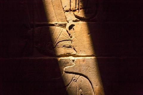 Stone wall with Egyptian carving figures and hieroglyphs, Luxor, Egypt