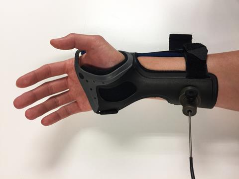 A picture showing a glucose monitoring device from a human forearm