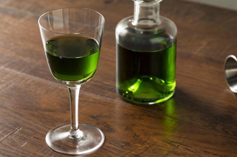 Glass and bottle of absinthe