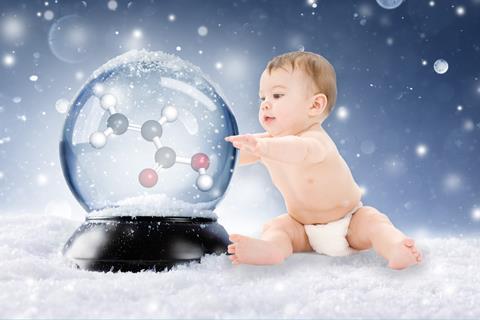 A baby in a disposable nappy with a snowglobe