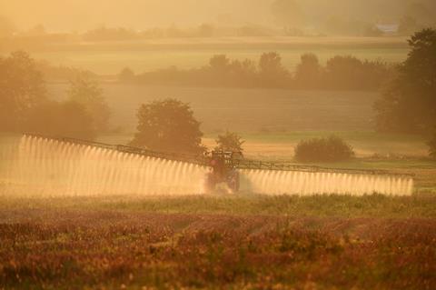 An image showing the spraying of a field with glyphosate