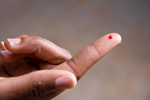 Drop of blood on a finger