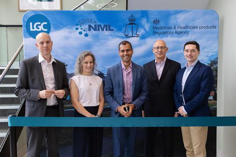A group photo of five people in professional clothes