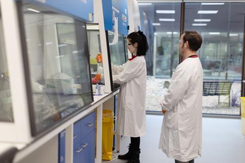 Scientists working at a fumehood