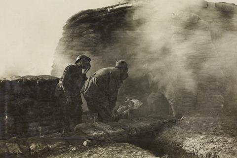 Stretcher bearers with a wounded in a trench during the release of asphyxiating gas, soldiers with gas-masks, World War I, Italy, 20th century.