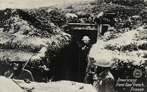 Early 1900's WWI postcard depicting Americans in a front line trench in France with gas masks on.