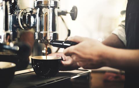 Barista making coffee in a cafe