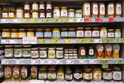 Assorted jars of honey on supermarket shelves