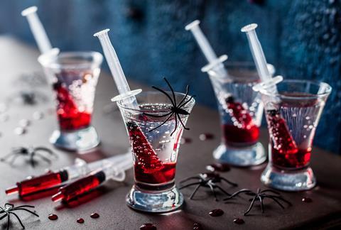 Halloween themed drinks with blood-red Grenadine syrup in syringes