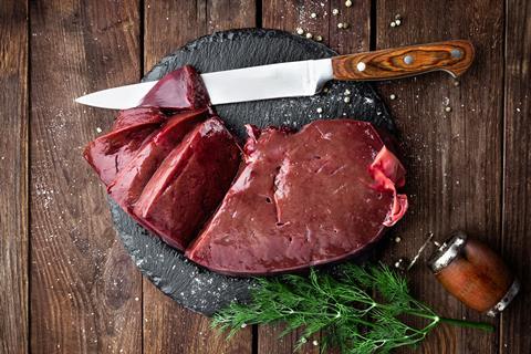 Raw liver being seasoned and prepared