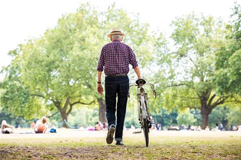 A picture of an old man with a bike