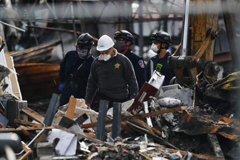 An image showing a coroner responsible for identifying victims from the Illinois factory explosion