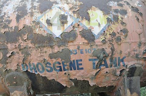 a rusty tank with phosgene written on it