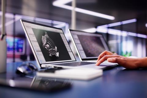 A person using professional CAD software on a laptop with their hand on the keyboard
