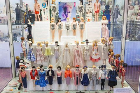 Vintage Barbie dolls in a display case