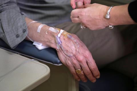 An image showing a patient's hand during an aducanumab clinical trial