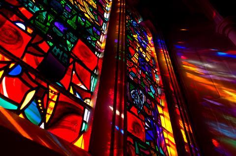 Lights shining through stained glass window 