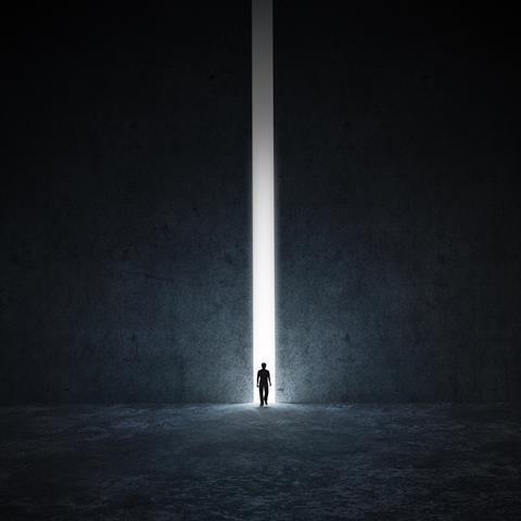 Person walking through tunnel of light