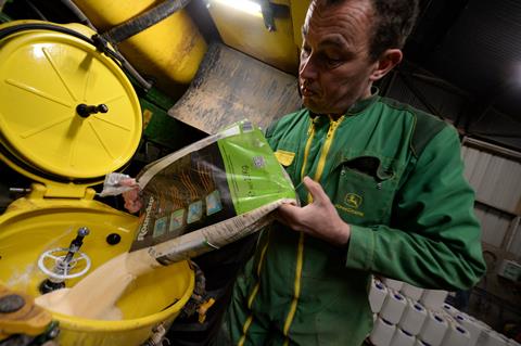 Farmer filling sprayer with glyphosate