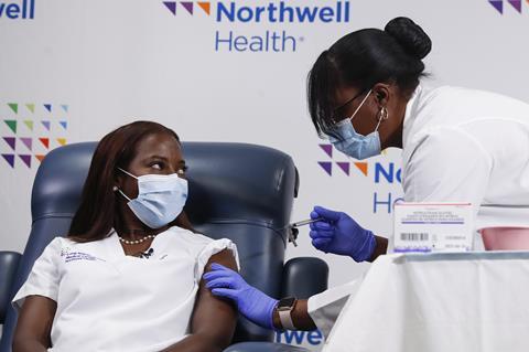 An image showing a New York nurse receiving the covid vaccine