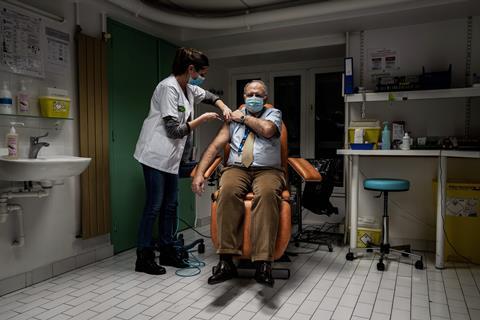 An image showing the vaccination of a man with the Pfizer-BioNTech Covid-19 vaccine