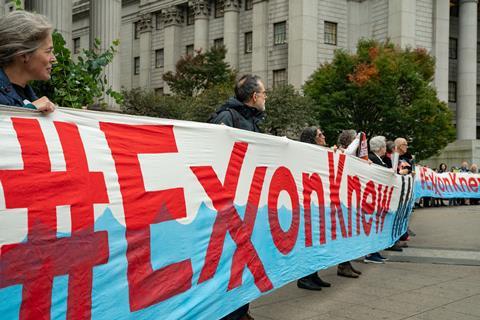 Climate demonstrators holding banners saying 'Exxon Knew'
