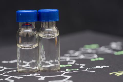 Close-up blue cap sample vial on paper with chemical formula of Oxytocin (love hormone)