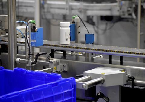 Drug bottle on conveyor belt