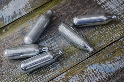 A photograph of nitrous oxide canisters