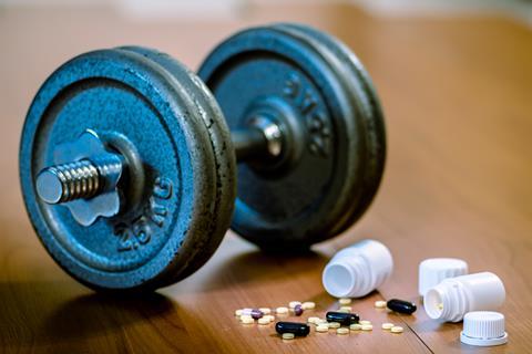 Dumbbell and steroid tablets