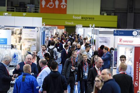 Busy corridor between stands in an exhibition hall