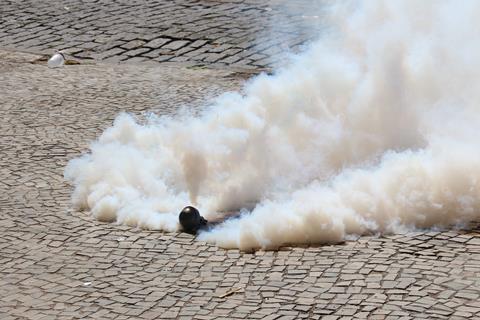 Tear gas bomb exploding on the floor.
