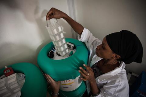 An image showing a woman handling vaccines