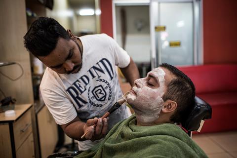 Man undergoing facial using skin lightening products