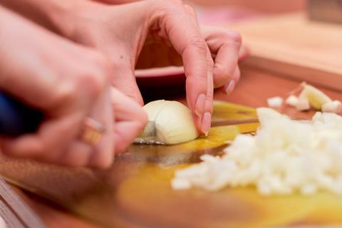 Chopping onions on a wooden board