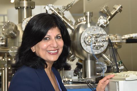 A photograph of Rasmita Raval in the lab