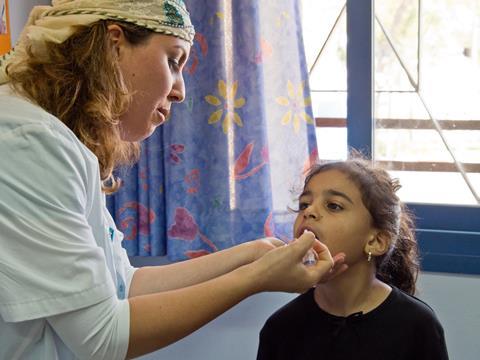 Young girl receiving the polio vaccine