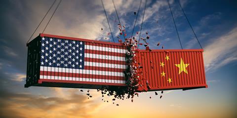 An illustration of cargo containers painted with US and Chinese flags crashing into each other, representing the trade war between the two countries