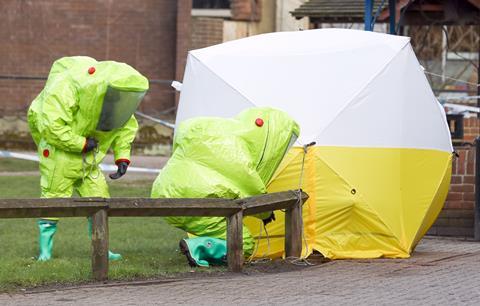 Investigators wearing hazmat suits whilst securing a tent for investigations into the Novichok poisonings 