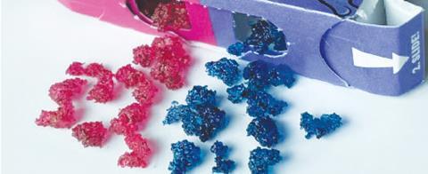 An image showing a number of pink and blue blob-like protein sweets spilling out of a Nerds package