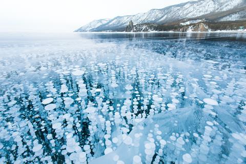 Bubbles of methane gas frozen into clear ice