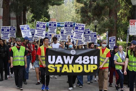 Workers marching with a banner