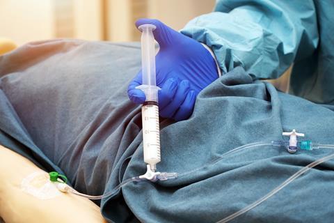 Doctor injects patient intravenously with the drug propofol