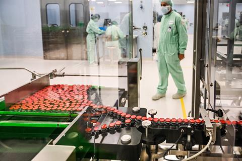 A photo of a clean facility with hundreds of glass vial to be filled.