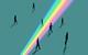 An image showing silhouetted people stepping in and out of a beam of rainbow